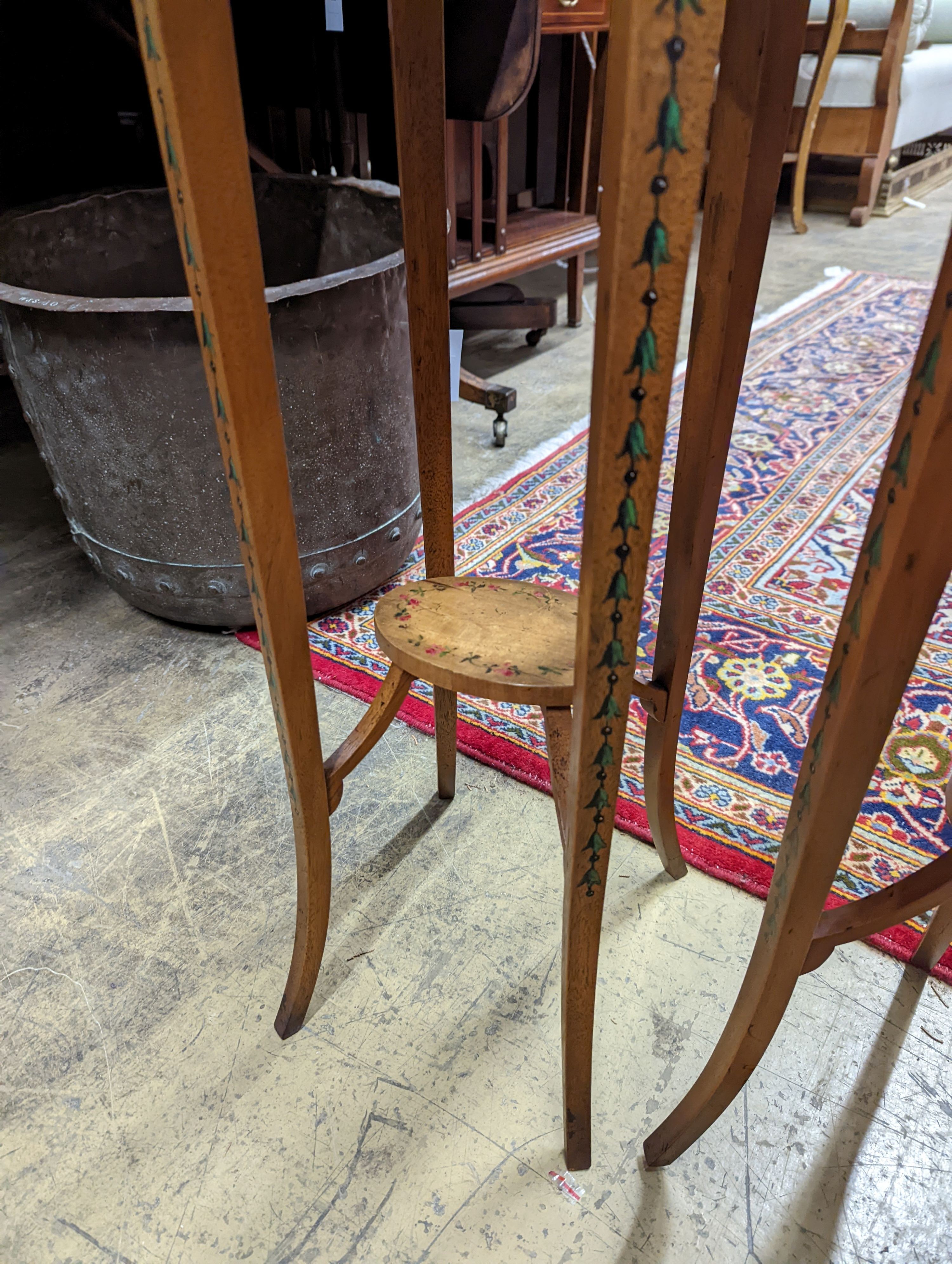 A pair of Sheraton style oval painted satinwood occasional tables, width 31cm, depth 26cm, height 71cm